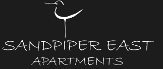 A logo for Sandpiper East Apartments featuring a white bird against a black background.